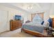 Cozy main bedroom with neutral walls, carpet, TV, and tray ceiling at 14429 Planters Knob Ln, Charlotte, NC 28273