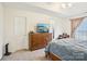 Main bedroom featuring a large dresser, TV and neutral walls at 14429 Planters Knob Ln, Charlotte, NC 28273