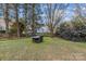 Backyard featuring an outdoor dining set on a well-manicured lawn at 1509 Orange Hill Ct, Gastonia, NC 28056