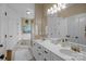 Bright bathroom featuring a double vanity, tub, and glass-enclosed shower at 1509 Orange Hill Ct, Gastonia, NC 28056