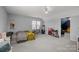 Bedroom with light-gray walls, a low window, and decoratively arranged furniture at 1509 Orange Hill Ct, Gastonia, NC 28056