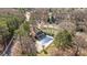 Aerial shot of the community pool and deck with mature trees surrounding it at 1509 Orange Hill Ct, Gastonia, NC 28056