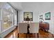 Bright dining room with a large arched window, hardwood floors, a modern buffet, and an art display at 1509 Orange Hill Ct, Gastonia, NC 28056