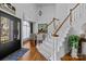 Inviting entryway features a wooden staircase, hardwood floors, a black front door, and high ceilings at 1509 Orange Hill Ct, Gastonia, NC 28056