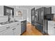 Updated kitchen with stainless steel appliances, white cabinets, and wood flooring at 1509 Orange Hill Ct, Gastonia, NC 28056