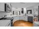 Bright kitchen features white cabinets, stainless steel appliances, and hardwood floors at 1509 Orange Hill Ct, Gastonia, NC 28056