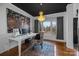 Office features a modern chandelier, white wainscoting, hardwood floors, and a bright picture window at 1509 Orange Hill Ct, Gastonia, NC 28056