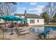 Backyard with in-ground pool, patio, lounge chairs, outdoor furniture, and the house in the background at 1509 Orange Hill Ct, Gastonia, NC 28056