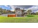 Unique home exterior with multi-level decks, stone retaining wall, and garage at 153 Badenyon Pl, Union Grove, NC 28689
