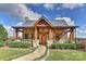Charming stone home with a metal roof, wooden beams, and a well-manicured front yard at 153 Badenyon Pl, Union Grove, NC 28689