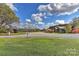 Exterior view showcasing homes with gravel driveway and expansive green lawn at 153 Badenyon Pl, Union Grove, NC 28689