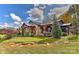 Exterior view of a home by a creek featuring wood and stone accents and a landscaped yard at 153 Badenyon Pl, Union Grove, NC 28689