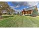 Exterior view of a well-manicured lawn, trees, and a charming home with stone and timber accents at 153 Badenyon Pl, Union Grove, NC 28689