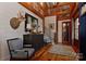 Grand foyer featuring hardwood floors, shiplap walls, exposed beams and stylish furnishings at 153 Badenyon Pl, Union Grove, NC 28689