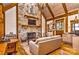 Cozy living room with stone fireplace, vaulted ceiling and hardwood floors at 153 Badenyon Pl, Union Grove, NC 28689