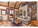 Inviting living room with vaulted ceilings, exposed beams, and a unique spiral staircase to a loft area at 153 Badenyon Pl, Union Grove, NC 28689