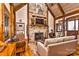 Inviting living room with a stone fireplace, vaulted ceilings, and rustic decor elements at 153 Badenyon Pl, Union Grove, NC 28689