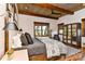 Comfortable main bedroom featuring wood paneling, a ceiling fan, and views of nature at 153 Badenyon Pl, Union Grove, NC 28689