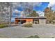 Rustic barn-style outbuilding with multiple bays for equipment storage, set on a gravel lot with mature trees at 153 Badenyon Pl, Union Grove, NC 28689