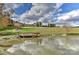 Scenic view of a pond reflecting the sky and a hillside with a fence and trees at 153 Badenyon Pl, Union Grove, NC 28689