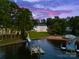 An aerial view of a luxurious home on a sprawling lawn leading to a private beach and boat docks at 16439 Jetton Rd, Cornelius, NC 28031