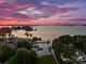 Breathtaking aerial view of a waterfront property with lush greenery, private docks, and stunning lake views at 16439 Jetton Rd, Cornelius, NC 28031