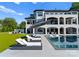 A sprawling backyard is perfect for outdoor entertainment, showcasing a pool, sun loungers, and green lawn at 16439 Jetton Rd, Cornelius, NC 28031