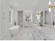 Bright bathroom featuring marble floors, modern fixtures, a soaking tub, and a glass enclosed shower at 16439 Jetton Rd, Cornelius, NC 28031