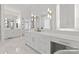 Bright bathroom featuring marble floors, white cabinets, and modern gold fixtures at 16439 Jetton Rd, Cornelius, NC 28031