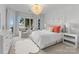 Bedroom with a chandelier, neutral tones, large windows, and waterfront view at 16439 Jetton Rd, Cornelius, NC 28031