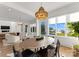 Stylish dining area with a unique chandelier, hardwood floors, and picturesque views at 16439 Jetton Rd, Cornelius, NC 28031