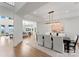 Elegant dining room featuring a modern chandelier, hardwood floors, and beautiful views of the outdoors at 16439 Jetton Rd, Cornelius, NC 28031