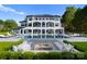 Stunning exterior view of an opulent home with an inground pool, multiple seating areas, and manicured grounds at 16439 Jetton Rd, Cornelius, NC 28031