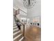 Grand foyer with a curved staircase, hardwood floors, soaring ceilings, and elegant chandelier lighting at 16439 Jetton Rd, Cornelius, NC 28031