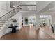 Spacious foyer with hardwood floors, a staircase, and views into the living and dining areas at 16439 Jetton Rd, Cornelius, NC 28031