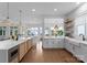 Open-concept kitchen featuring stainless steel appliances, granite countertops, and seamless integration with living area at 16439 Jetton Rd, Cornelius, NC 28031