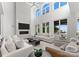 Bright, airy living room with tall windows, a cozy fireplace, and comfortable seating arrangements at 16439 Jetton Rd, Cornelius, NC 28031