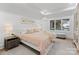 Beautiful main bedroom with tray ceiling, accent pillows, bedside lamps, and a water view at 16439 Jetton Rd, Cornelius, NC 28031