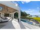 View of luxurious outdoor living space featuring a swimming pool, covered patio, and lake views at 16439 Jetton Rd, Cornelius, NC 28031