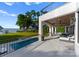 View of luxurious outdoor living space featuring a swimming pool, covered patio, and lake views at 16439 Jetton Rd, Cornelius, NC 28031
