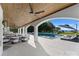 An inviting in-ground pool with sun loungers and ample seating under a covered patio with a ceiling fan at 16439 Jetton Rd, Cornelius, NC 28031