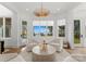 Bright sitting area featuring plush chairs, a round coffee table, and stunning views at 16439 Jetton Rd, Cornelius, NC 28031