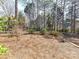 Backyard with treeline, bench, stone features and wrought iron fence at 18322 Indian Oaks Ln, Davidson, NC 28036