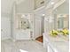 Bright bathroom with marble floors, double vanities, and vaulted ceilings at 18322 Indian Oaks Ln, Davidson, NC 28036
