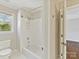 Bright bathroom featuring a tub/shower combo and view to the backyard at 18322 Indian Oaks Ln, Davidson, NC 28036