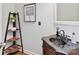 Stylish bathroom featuring a dark stone sink, decorative shelving, and neutral wall paint at 18322 Indian Oaks Ln, Davidson, NC 28036