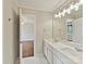 Bright bathroom with marble floors, double vanities, and modern light fixtures at 18322 Indian Oaks Ln, Davidson, NC 28036