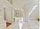 Bright bathroom with marble floors, double vanities, and vaulted ceilings at 18322 Indian Oaks Ln, Davidson, NC 28036