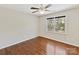 Cozy bedroom featuring hardwood floors, a ceiling fan, and a view of the backyard at 18322 Indian Oaks Ln, Davidson, NC 28036