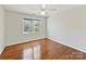 Cozy bedroom featuring hardwood floors, a ceiling fan, and a view of the backyard at 18322 Indian Oaks Ln, Davidson, NC 28036